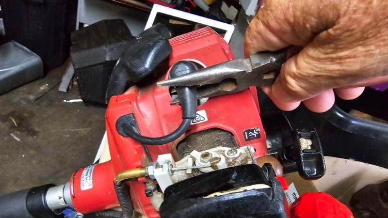 Pulling off a spark plug cap with pliers