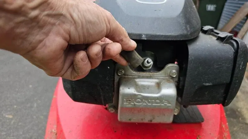 Lawn Mower Spark Plug being removed