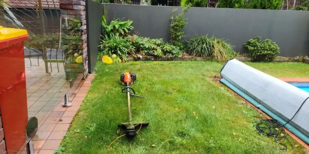 A weed eater on a nice lawn