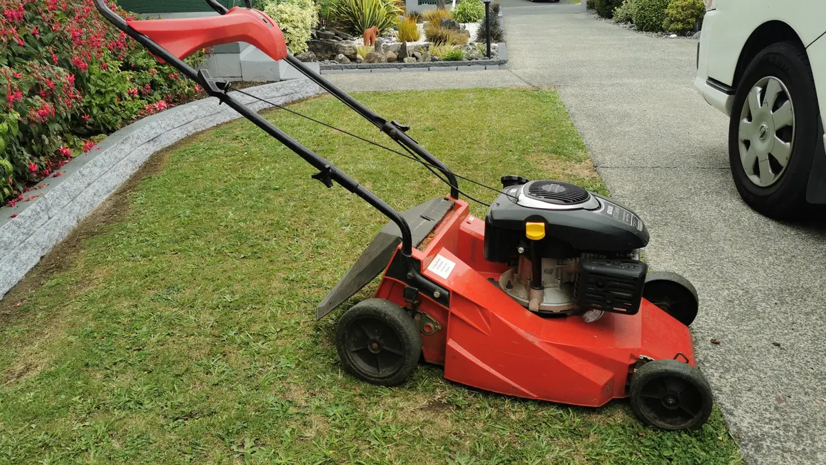 Mower on a front lawn by the driveway