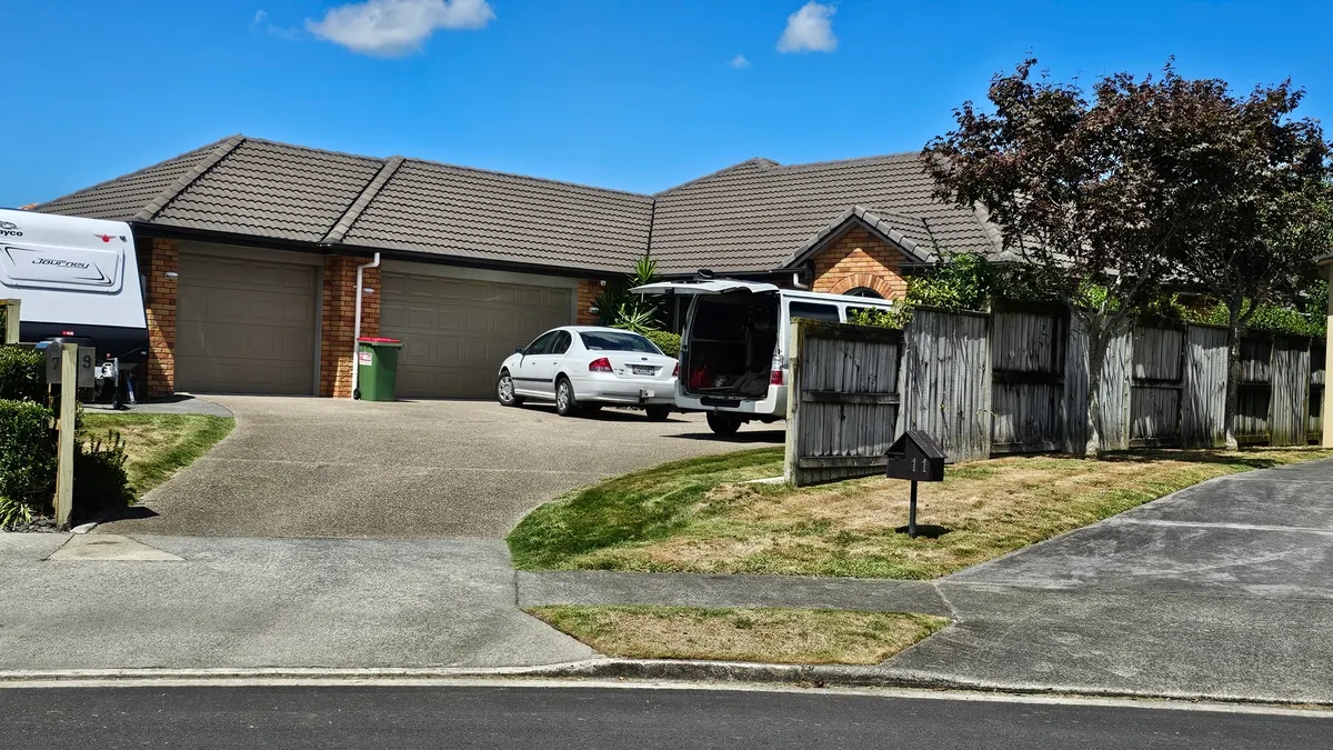 Lawn care van parked with the back open in a customer's driveway on a mowing day