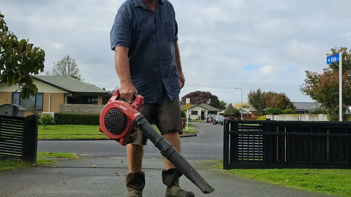 Blowing clippings off the driveway after a mow