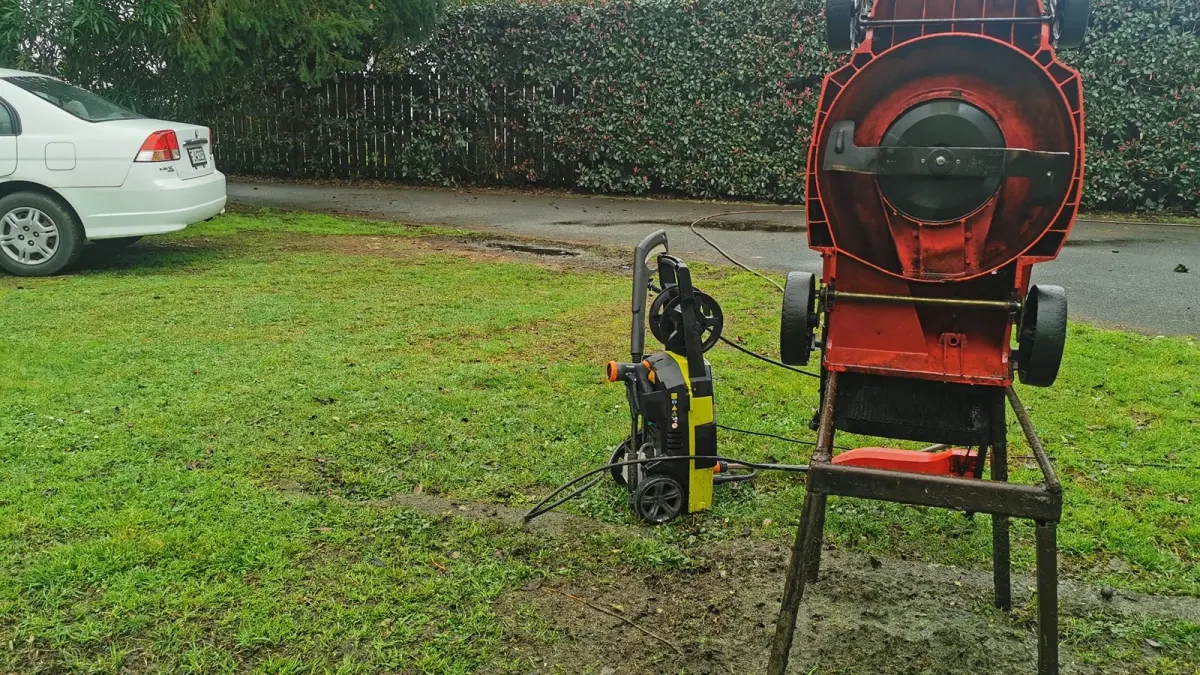 A wood chipper and a water blaster on a customer's lawn, another contractor's gear on site while I was mowing