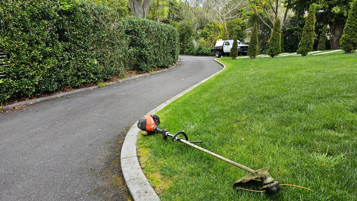 Line trimmer on a curved front lawn edge