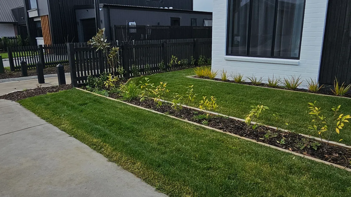 Freshly trimmed garden edge along a front lawn