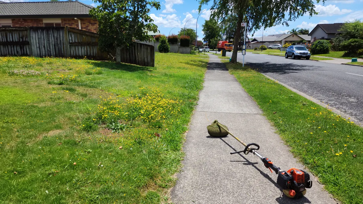 Line trimmer on a footpath edge