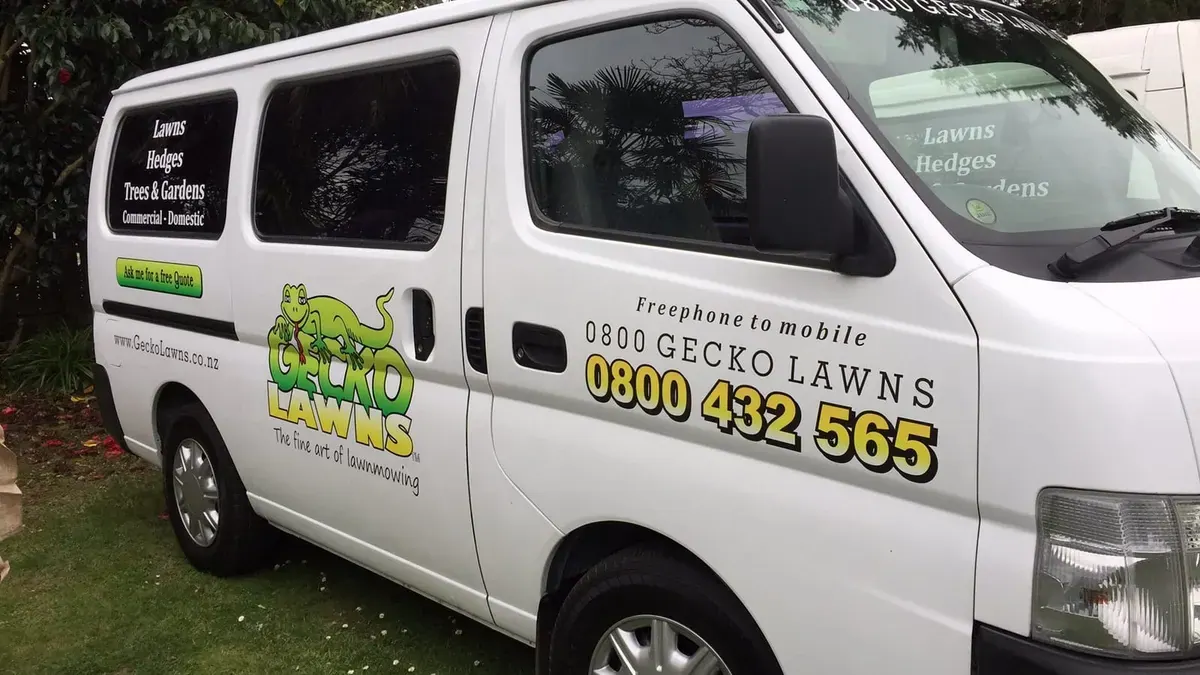 Gecko Lawns signwritten van with the gecko logo and tagline on the side