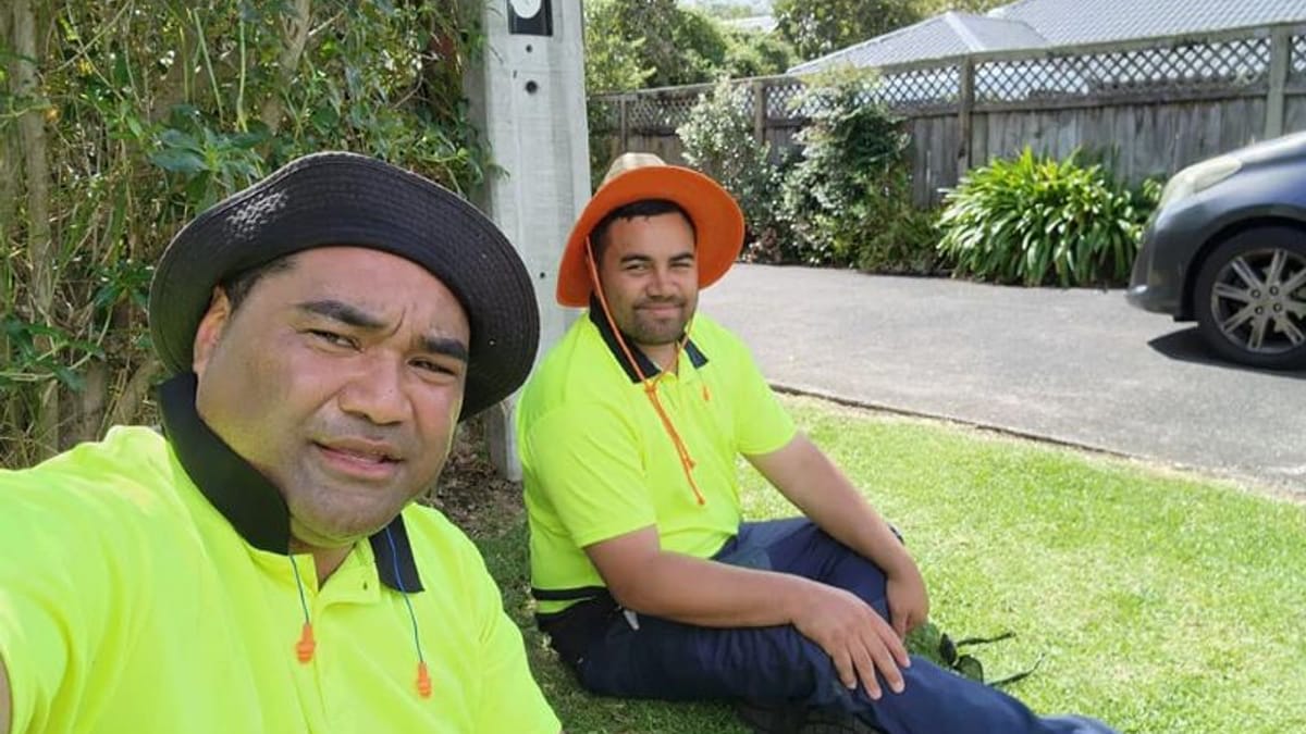 Two lawn mowing partners taking a break on the job