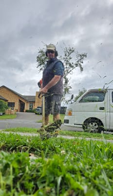 Line trimming a berm next to the van